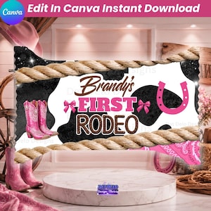 May include: A rectangular sign design featuring a black and white cow print background, a pair of pink cowboy boots, a pink horseshoe, and two pink bows. The text reads Brandy's FIRST RODEO in brown and pink, framed by a thick tan rope border.
