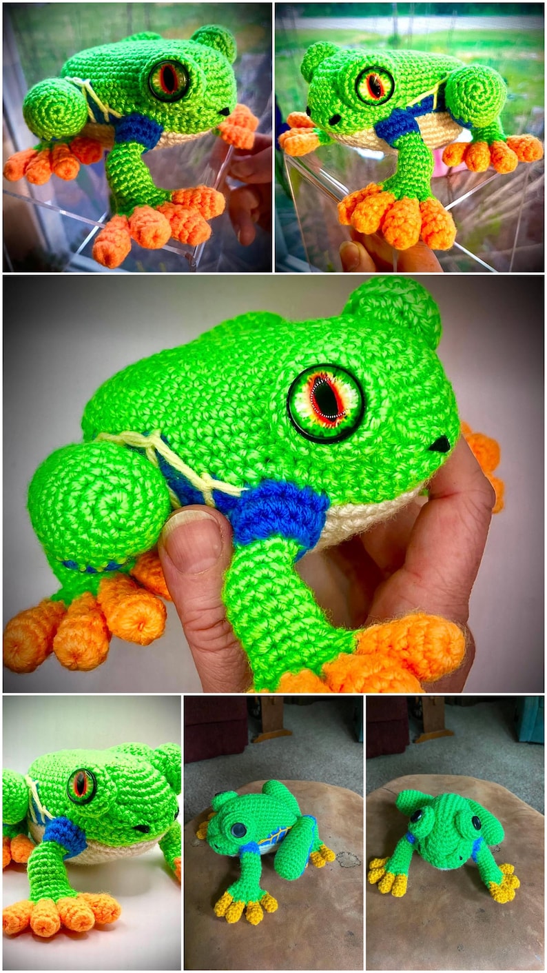 May include: A handcrafted crochet frog toy featuring a bright green body, orange feet, and blue accents along the sides. The plush figure has large, detailed eyes with red and black irises and a cream-colored underside, showcasing intricate yarn stitching throughout.