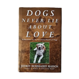 May include: A book titled "Dogs Never Lie About Love: Reflections on the Emotional World of Dogs" by Jeffrey Moussaieff Masson, author of "When Elephants Weep". The cover features a brown and white dog with a brown background.