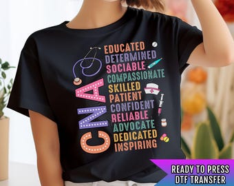 May include: Black t-shirt with a colorful graphic design that spells out "CNA" and lists qualities of a CNA, such as "educated", "determined", "sociable", "compassionate", "skilled", "patient", "confident", "reliable", "advocate", "dedicated", and "inspiring". The text "READY TO PRESS DTF TRANSFER" is at the bottom of the image.