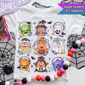 May include: A white t-shirt with a Halloween-themed design featuring cartoon characters dressed in costumes. The characters are holding buckets and candy. The text "READY TO PRESS DTF TRANSFER" is visible in the top right corner.