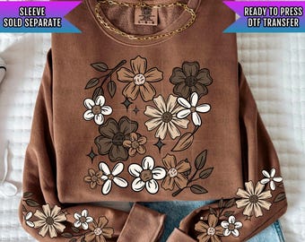 May include: Brown sweatshirt with a floral design in shades of brown, white, and beige. The text "READY TO PRESS DTF TRANSFER" is printed on the top right corner of the sweatshirt.