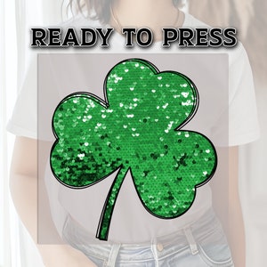 May include: Green sequin shamrock iron-on patch, ready to press.  Perfect for adding a touch of Irish charm to clothing or crafts.