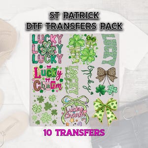 May include: A collection of St. Patrick's Day DTF transfers. The designs include shamrocks, bows, and the words "Lucky" and "Lucky Charm" in various fonts and colors. The transfers are in shades of green, pink, and gold.