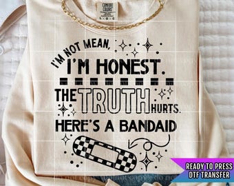 May include: A beige sweatshirt with a black graphic design that reads "I'm not mean, I'm honest. The truth hurts. Here's a bandaid." The graphic includes a black and white checkered bandaid.