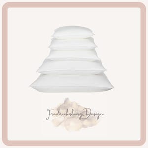 May include: A stack of six white pillows of varying sizes, arranged from smallest at the top to largest at the bottom. The pillows are on a light background, with the text "Fredericksburg Design" below.