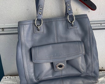 Coach light blue/grey shoulder bag in great condition. Outside pocket and 2 inside. Textured soft leather. Magnetic snaps on inside pockets