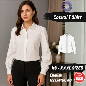 Può includere: Una camicia bianca abbottonata con maniche lunghe e colletto classico. La camicia è abbinata a pantaloni neri. Il testo sull'immagine recita "Casual T Shirt" e "XS - XXXL SIZES". È visibile anche un'icona PDF.