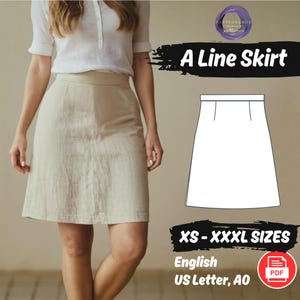 May include: A line skirt sewing pattern in white, with a woman wearing a beige skirt in the background. The pattern is for sizes XS-XXXL and is available in English, printed on US Letter or A0 paper. The pattern is a PDF download.