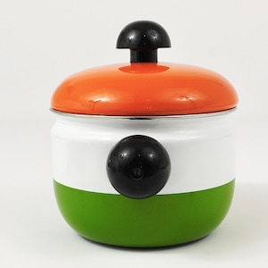 May include: A round enamel canister featuring a vibrant orange lid with a black knob, a white middle section, and a green base. A prominent black circular knob is attached to the centre of the white section, providing a contrast to the colours.