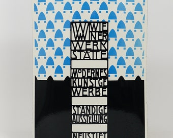 May include: A black and white enamel sign with blue accents. The sign advertises the "Wiener Werkstätte" with the text "Modernes Kunstige Werbung" and "Ständige Ausstellung" and "Neustiftgasse 32".