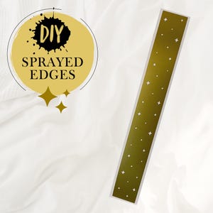 May include: A gold stencil with a repeating pattern of small white stars. The stencil is labelled "DIY SPRAYED EDGES".