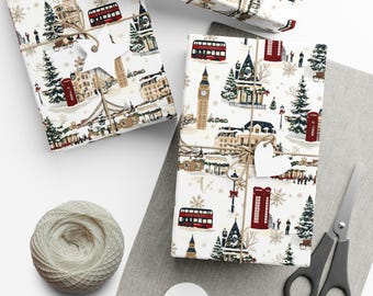 May include: Wrapped gifts with London-themed wrapping paper featuring red double-decker buses, phone booths, and Big Ben. The gifts are tied with twine and adorned with star and heart-shaped tags. A ball of twine and scissors are also present.