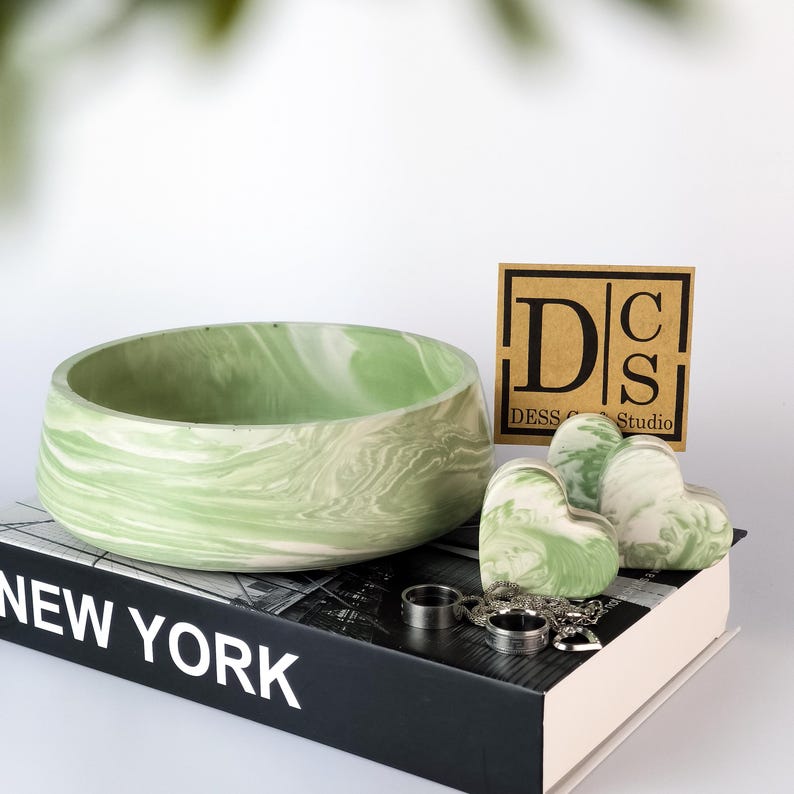 Hand-poured marble catchall tray centered on a white minimalist background highlighting the deep black mineral pigments.