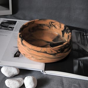 Top-down view of a handmade marbled mineral composite bowl showcasing the unique abstract pattern inside the vessel.