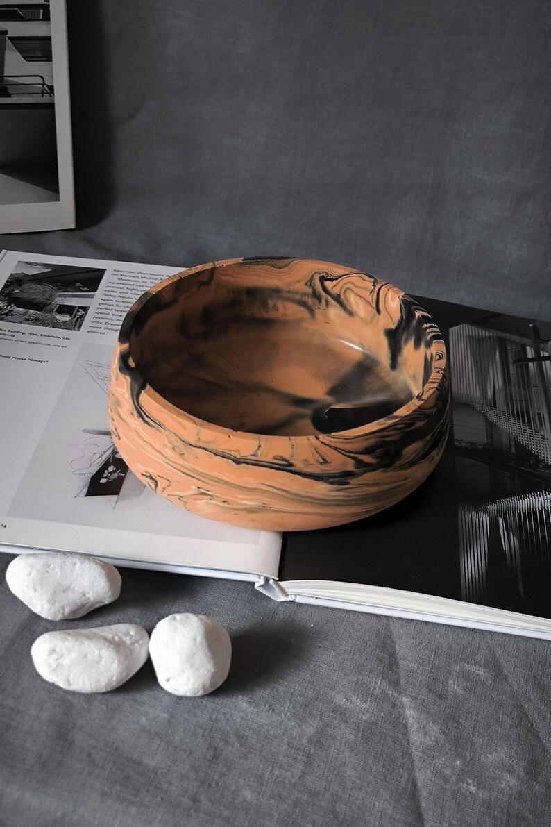Top-down view of a handmade marbled mineral composite bowl showcasing the unique abstract pattern inside the vessel.