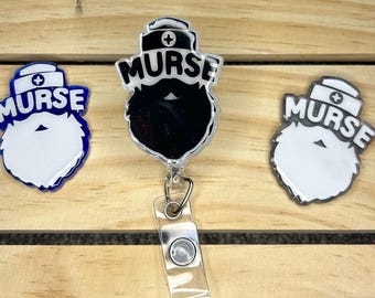 May include: Three nurse-themed badge reels with a white beard and a blue, black, and silver background. The badge reels have the word "NURSE" written on them.