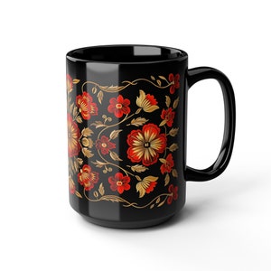 May include: Black ceramic mug with a floral design featuring red and gold flowers on a black background.