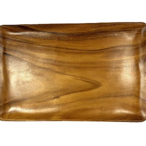 May include: A rectangular wooden tray with rounded corners. The tray is made of a light brown wood with a visible grain pattern. The tray is empty and sits on a white background.