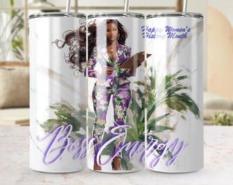 May include: A white tumbler with a design featuring a woman in a purple floral suit holding a clipboard. The words "Boss Energy" and "Happy Women's History Month" are also displayed.