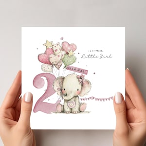 May include: A birthday card with a watercolour illustration of an elephant holding heart-shaped balloons. The card features the number 2 in pink, the text "To a special Little Girl", and the name "Ella Mae".