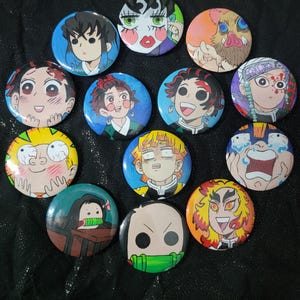 May include: A collection of round, colorful anime character button pins. Each pin features a different character with unique facial expressions and vibrant colors. The pins are arranged on a dark, glittery surface.