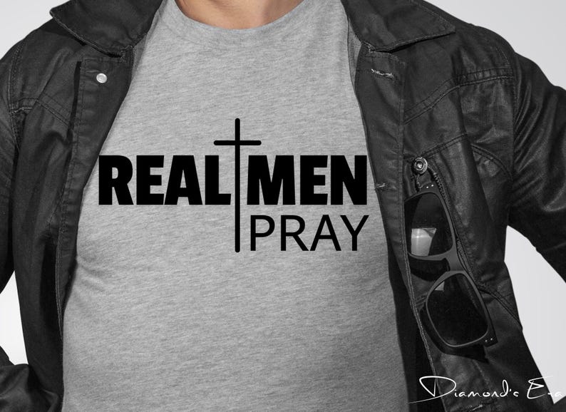 May include: A gray t-shirt with the text "REAL MEN PRAY" and a cross graphic.