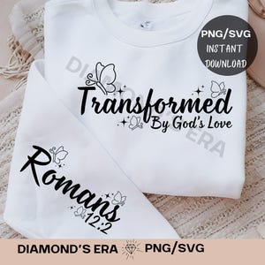 May include: White sweatshirt with black text and butterfly designs. The text reads "Transformed By God's Love" and "Romans 12:2".