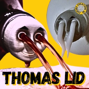 May include: A close-up of a red and white bottle with a cartoon face and two red beams of light shooting out of its eyes. The bottle is labelled "Cursed 3D Creations" and is pointed at a white object with two white tentacles.