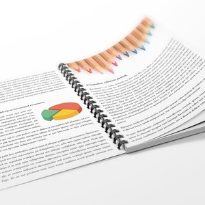 May include: An open spiral bound notebook with black binding. The pages are filled with text and a pie chart. A row of coloured pencils is on the top of the notebook.