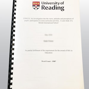 May include: A spiral-bound document from the University of Reading, with the university's logo at the top. The title reads "EDM133: An investigation into the views, attitudes and perceptions of pupils' participation in extra-curricular activities." The word count is 15887.