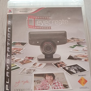 May include: A white ceramic mug with a black handle and the text "But First, Coffee" in a bold, black font. The mug is on a wooden surface. The mug is 10 cm tall.