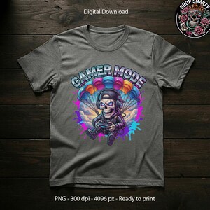 Dynamic gaming illustration featuring a skull character wearing a headset and gaming controller while skydiving with a rainbow parachute. The artwork uses bright neon colors, graffiti paint splashes, and streetwear-inspired design elements, making it ideal for gamer tee graphics, digital download artwork, and sublimation projects.