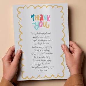 May include: A printed card with a yellow scalloped border and the words "THANK YOU" in colorful letters. The card contains a poem expressing gratitude. The card is held by two hands.