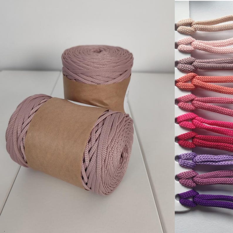 Dusty rose braided polyester cord skeins wrapped in kraft paper, shown on a white surface. Soft, chunky texture with tightly woven strands. Multiple color variations displayed on the side for comparison of shades and thickness.