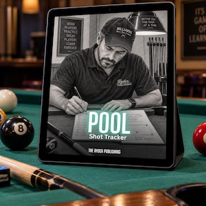 May include: A tablet displaying a Pool Shot Tracker book cover featuring a person in a cap writing in a notebook. The screen shows the text POOL Shot Tracker and THE RYDER PUBLISHING. The tablet sits on a green pool table with billiard balls.