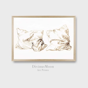 May include: A digital illustration of two white pillows in a gold outline, with the text "DivinusMoon Art Prints" below the image.