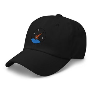 May include: Black baseball cap with an embroidered patch featuring a blue and orange rocket ship with stars.
