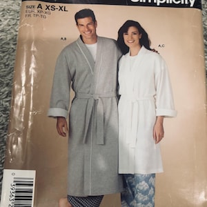 May include: A Simplicity sewing pattern envelope 4743 for robes in sizes XS-XL. The cover features a gray robe with white trim and a white robe with a tie belt. The text reads IT'S SO easy IT'S Simplicity 4743 BIN 44 SIZE A XS-XL EUR. XP-XG FR. TP-TG.