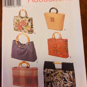 May include: A Simplicity pattern for accessories, featuring six different bag designs. The bags showcase various styles, including floral prints, solid colors, and patterned fabrics. The pattern includes bamboo handles and a variety of shapes and sizes.