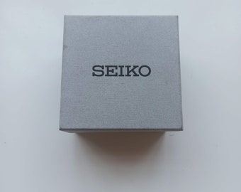 Caja de reloj de pulsera Seiko original vintage en buen estado.