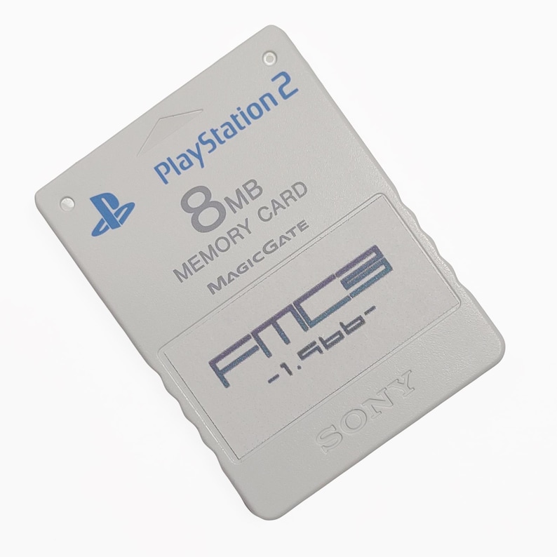 May include: A light gray PlayStation 2 8MB Memory Card with the PlayStation logo and the text "MAGICGATE". The card also features the text "FMC3 -1.56b-" and the Sony logo.