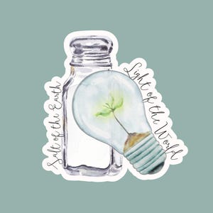 May include: Watercolor sticker featuring a salt shaker and a lightbulb with a green plant inside. The words "Salt of the Earth" and "Light of the World" are written in script around the objects. The background is a muted teal color.