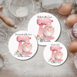May include: Three round stickers featuring a pink stand mixer with a glass bowl filled with flowers. The stickers have text that reads "Baked with Love by Charlotte", "Homemade With Love Wendy's Kitchen", and "Custom Text".