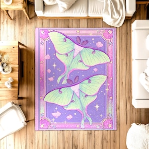 May include: A rectangular rug with a fantasy design of two luna moths. The moths have mint green wings and purple bodies, set against a lavender background with stars and clouds. The rug is framed with a pink border.