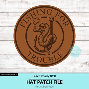 May include: A brown circular hat patch file with the text "FISHING FOR TROUBLE" around the edge. The patch features a cartoon worm smoking a cigar on a fishing hook. The words "HAT PATCH FILE" are at the bottom.