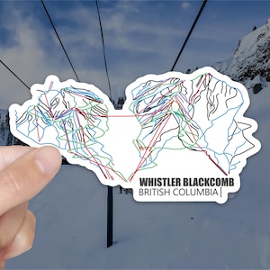 May include: A white sticker with a black and white outline of the Whistler Blackcomb ski resort map. The sticker has the text "Whistler Blackcomb" and "British Columbia" in black text.