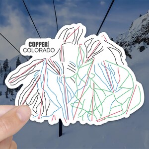 May include: A white sticker with a black outline of a ski resort trail map. The map shows different colored lines representing different difficulty levels. The text "COPPER COLORADO" is printed in black at the top of the sticker.