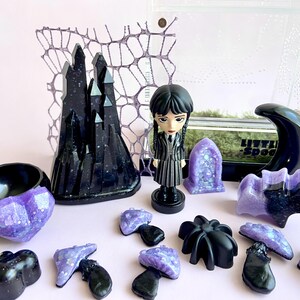 Handmade gothic jumping spider enclosure décor including castle, mushrooms, moon hide, crystals and Wednesday Addams figure.