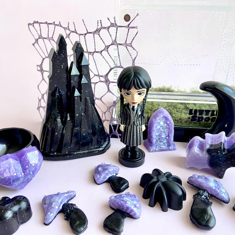 Handmade gothic jumping spider enclosure décor including castle, mushrooms, moon hide, crystals and Wednesday Addams figure.